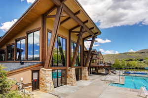 View of pool with a patio and a mountain view