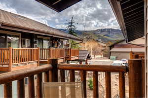 View of yard with a mountain view and a balcony