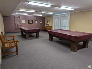 Game room featuring billiards table and a textured ceiling