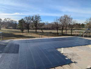 View of pool featuring view of scattered trees