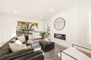 Living room featuring a fireplace, recessed lighting, and wood finished floors