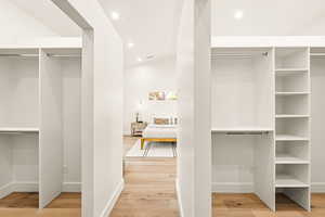 View of dual walk-in closets in primary bedroom