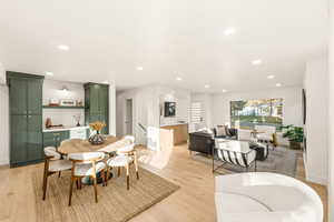 Dining space featuring light wood flooring, recessed lighting, and built-ins