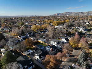 Aerial view of property's location with mountains and nearby suburban area
