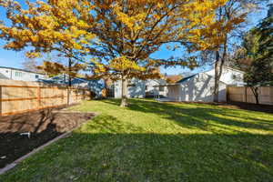 Fenced backyard with a patio