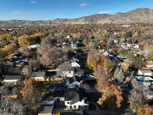 Aerial view of property's location with a mountain backdrop and nearby suburban area
