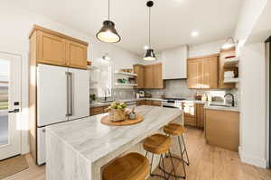 Kitchen with open shelves & light wood floors