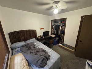 Bedroom featuring carpet, a closet, a ceiling fan, and a textured ceiling