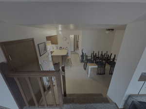 Stairway featuring a textured wall