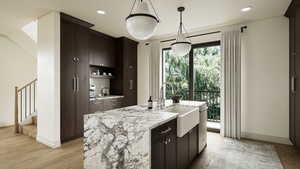 Renderings are for illustrative purposes only.Features, finishes, dimensions, layouts, landscaping, and amenities shown are conceptual and subject to change without notice. Actual construction may vary. Kitchen featuring light stone countertops, hanging