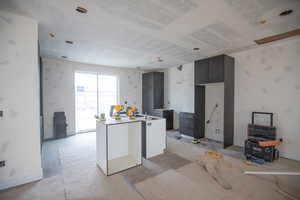 Kitchen featuring a kitchen island and baseboards