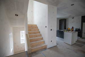 Stairs featuring wallpapered walls