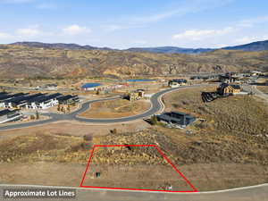 Aerial overview of property's location with a mountainous background and property parcel outlined