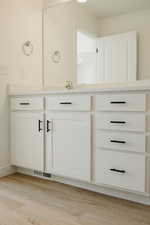 Bathroom with vanity and light wood finished floors