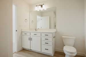 Bathroom featuring vanity and light wood-style floors