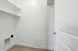 Washroom with light wood-type flooring and baseboards