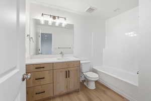 Bathroom featuring vanity, light wood finished floors, and shower / tub combination