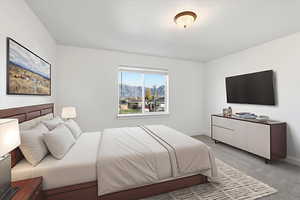 Bedroom with light colored carpet and baseboards