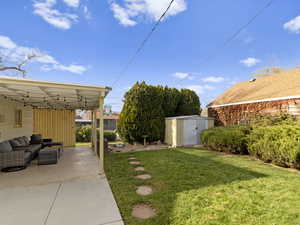 View of yard featuring a storage shed and an outdoor hangout area