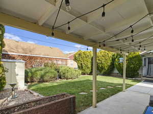 View of green lawn with a patio