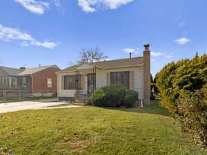 Bungalow-style home with a chimney