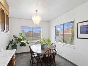 Dining room with baseboards and a chandelier