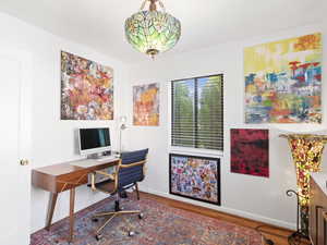 Office space featuring baseboards and wood finished floors