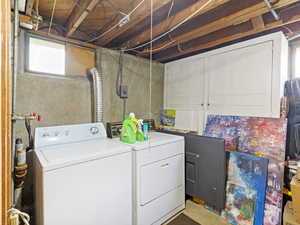Laundry room with separate washer and dryer, healthy amount of natural light, and concrete floors