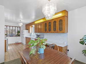 Dining area with a chandelier and light flooring