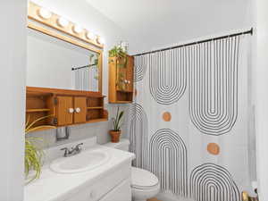 Full bath featuring vanity and tasteful backsplash