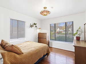 Bedroom featuring baseboards and wood finished floors