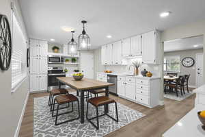 Dining room featuring dark wood-style flooring and recessed lighting