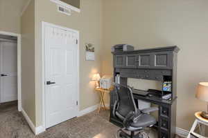 Home office featuring baseboards and light carpet