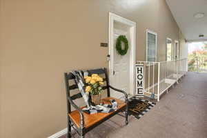 Entrance to property with stucco siding and a porch