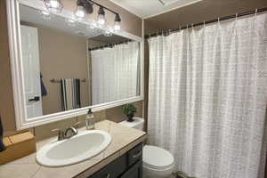 Full bath with vanity and a shower with shower curtain