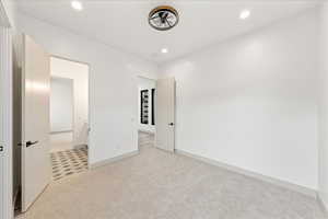 Unfurnished bedroom featuring light colored carpet and recessed lighting