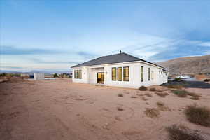 Back of property with a patio, a mountain view, and stucco siding