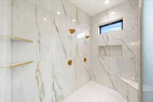 Bathroom featuring a marble finish shower and recessed lighting