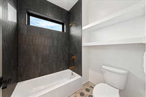 Full bathroom featuring bathing tub / shower combination and toilet