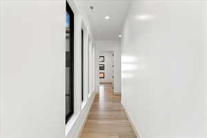 Hallway featuring recessed lighting and light wood-type flooring