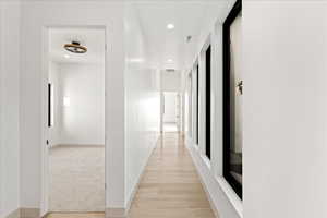 Hall with recessed lighting and light wood-style flooring