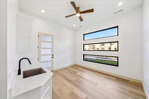 Washroom with light wood-style flooring, recessed lighting, and ceiling fan