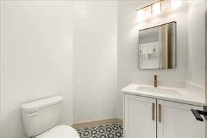 Hall bathroom with vanity and toilet