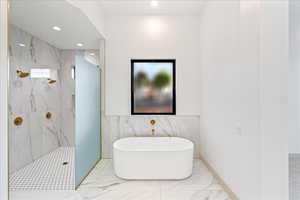 Bathroom with a soaking tub, a marble finish shower, recessed lighting, and marble finish floors