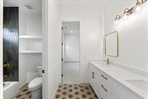 Full bath featuring double vanity and shower / tub combination