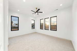 Carpeted Primary room with a ceiling fan and recessed lighting