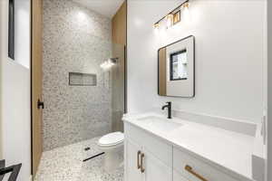 Full bath with a shower stall and vanity