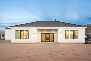 Back of house with stucco siding and a mountain view