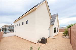 View of property exterior with a fenced backyard and stucco siding