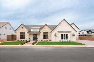View of front of house with a standing seam roof, stone siding, and a metal roof